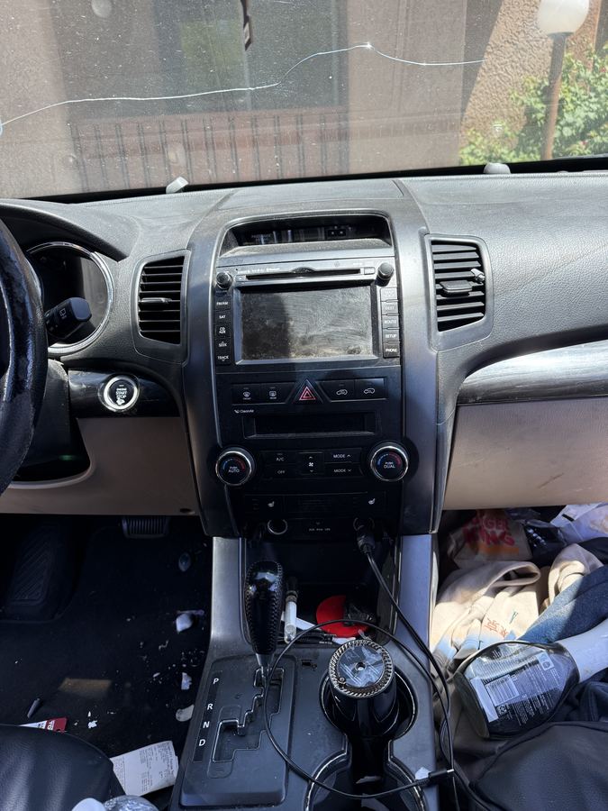 Heavily cluttered center console and dashboard before deep detail