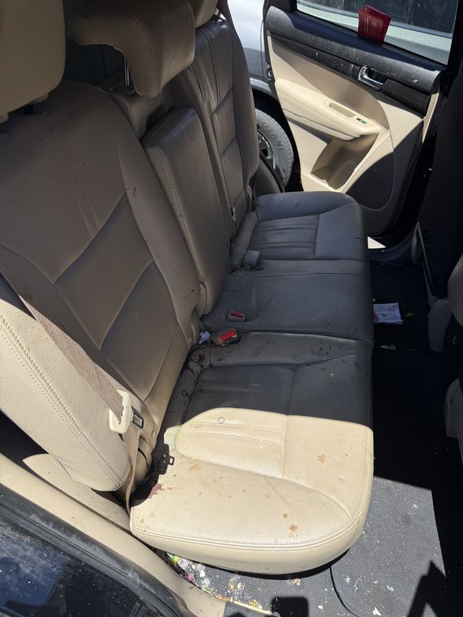 Stained and dirty rear seats before detailing